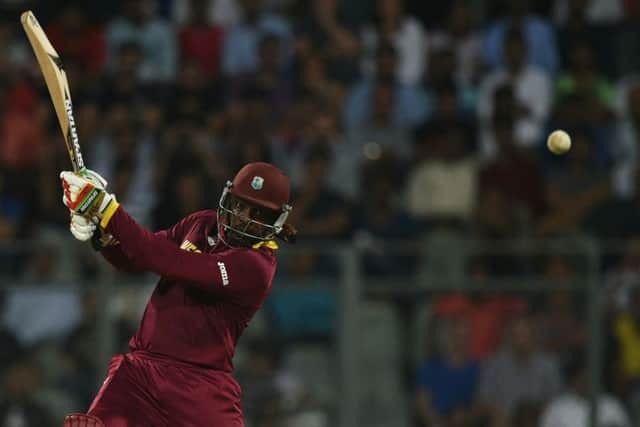 Chris Gayle smashes another six on his way to 100 not out and victory over England. Picture: Getty