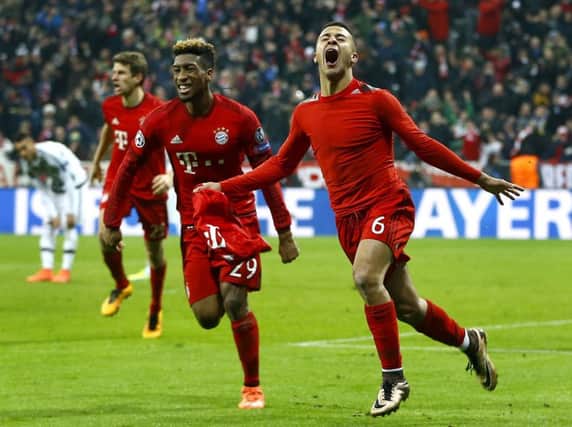 Thiago Alcantara, right, celebrates after scoring Bayern Munich's third goal against Juventus as the Germans claimed a 6-4 aggregate win to reach the last eight. Picture: AP