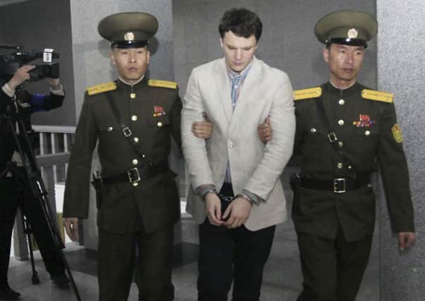 American student Otto Warmbier, center, is escorted at the Supreme Court in Pyongyang, North Korea Picture: AP Photo/Jon Chol Jin