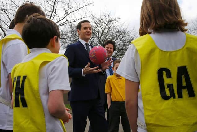 Chancellor George Osborne got a netball lesson on a school visit in West Yorkshire yesterday as the nation digested the Budget news. Picture: AFP/Getty