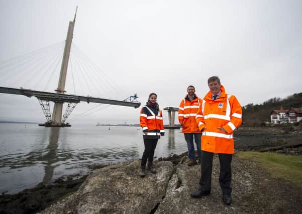 Keith Brown pictured with Jared Carlson and Jennifer Bullingham, engineers who have worked on the launch of the Queensferry Crossing's north approach viaduct, successfully launched earlier this month. Picture: Transport Scotland