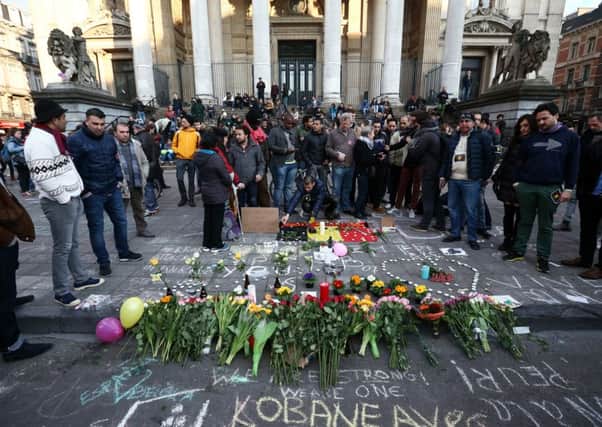 People gather to leave tributes at the Place de la Bourse following Tuesday's attacks. Picture: Getty