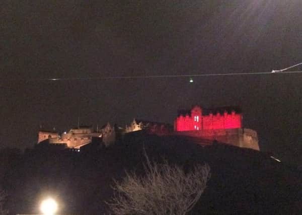 Edinburgh Castle lit up in colours of Belgium flag