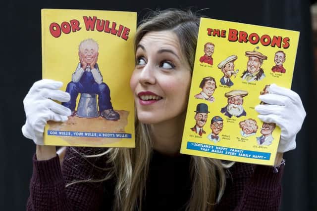 Areti Chavale of Bonhams with the first ever Broons and Oor Wullie annuals, dating from the 1940s. Picture: PA
