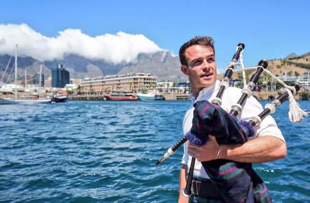 Ross Jennings is aiming to pipe in every country - here he is in the shadow of South Africa's Table Mountain. Picture: Twitter/@firstpiper