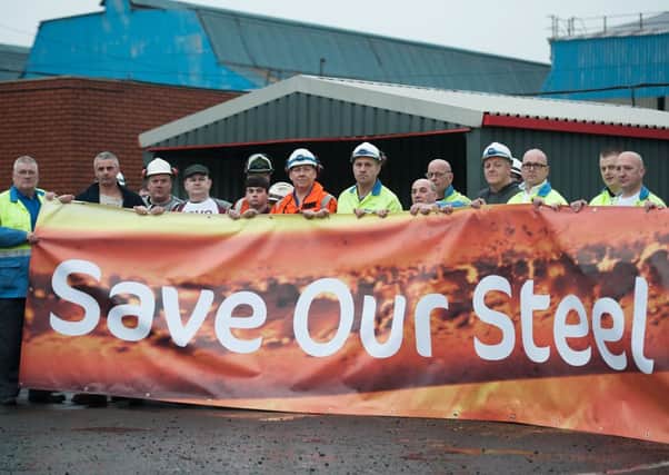 Dozens of Tata steelworkers unveil Save Our Steel banner before boarding a coach bound for the Scottish Parliament in November. Picture: John Devlin