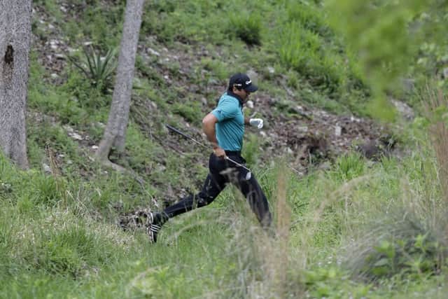 Australia's Jason Day jumps over a creek as he looks for his ball on the fourth hole during the Dell Match Play Championship in Austin. Picture: Eric Gay/AP