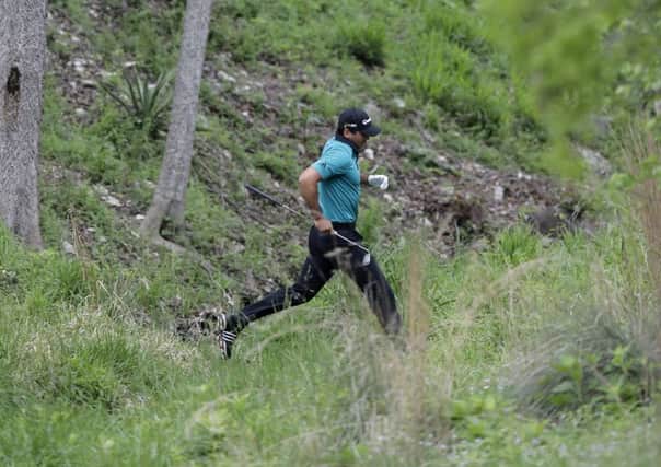Australia's Jason Day jumps over a creek as he looks for his ball on the fourth hole during the Dell Match Play Championship in Austin. Picture: Eric Gay/AP