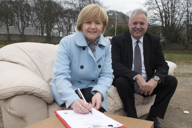 Aberdeen council leader Jenny Laing and Places for People CEO David Cowans sign the deal. Picture: Norman Adams/Aberdeen City Council