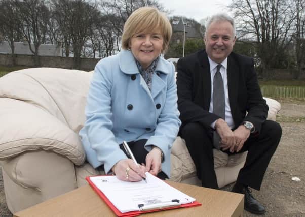 Aberdeen council leader Jenny Laing and Places for People CEO David Cowans sign the deal. Picture: Norman Adams/Aberdeen City Council