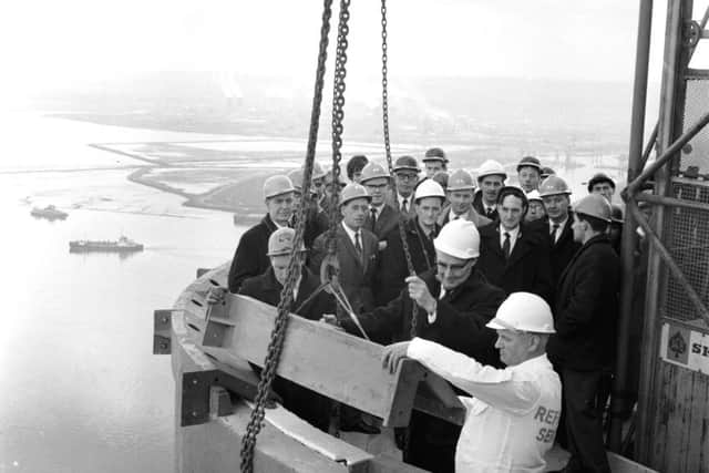 Mr Harry Morris pulls the chain to lower the last section of the cap into position during the Longannet Power Station chimney topping-out ceremony.