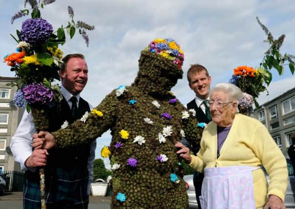 101yr old Kitty Redpath greets the Burryman in South Queensferry. PIC LISA FERGUSON.