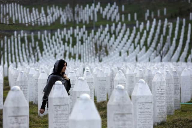 A Bosnian woman walks among gravestones at Memorial Centre Potocari near Srebrenica. Picture: AP