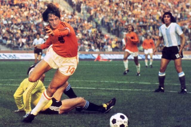 Johan Cruyff dribbles past Argentina goalie Daniel Carnevali during a 1974 World Cup quarter final match. Picture: AFP/Getty Images