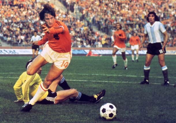 Dutch forward Johan Cruyff beats Argentina goalkeeper Daniel Carnevali on his way to scoring during the 1974 World Cup quarter-final in Gelsenkirchen. Picture: AFP/Getty Images