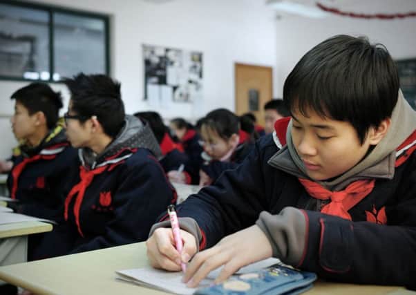 Pupils in a class at the Jingan Education College Affiliated School in Shanghai, where schools have more autonomy and have high attainment. Picture: AFP/Getty Images