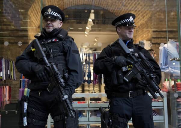 Armed British police officers stand guard after Eurostar services were suspended after the attacks in Belgium. Picture: AP
