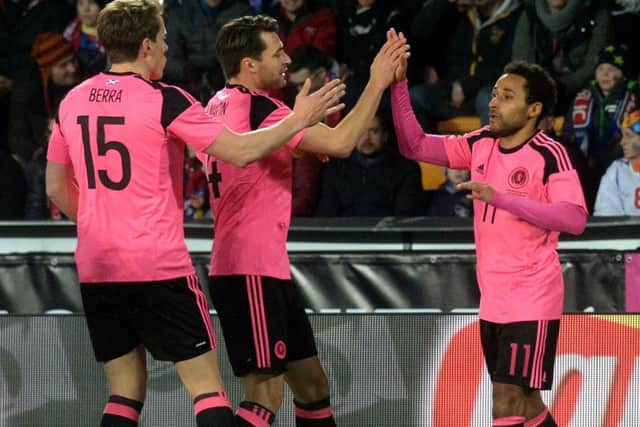 Ikechi Anya, right, celebrates with Scotland team-mates Christophe Berra and Russell Martin after his goal against Czech Republic. Picture: Michal Cizek/AFP/Getty Images