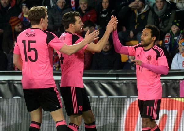 Ikechi Anya, right, celebrates with Scotland team-mates Christophe Berra and Russell Martin after his goal against Czech Republic. Picture: Michal Cizek/AFP/Getty Images