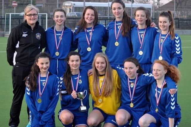 The High School of Glasgow team with their trophy.