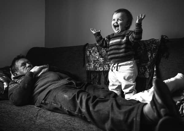 Alex Ingle's award-winning photo of the youngest member of the Nawrot family with his grandfather. Picture: Alex Ingle