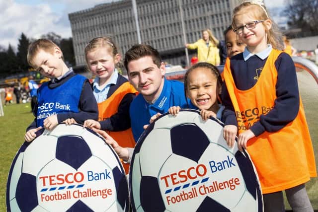 Aberdeen's Kenny McLean joins (L/R) Aaron Koziel, Maisy Le Poidevin, Michael Igwegbu, Zuzanna Obianwu and Maya Witowska from St. Peter's Primary School as he promotes the Tesco Bank Football Challenge. Picture: Gary Hutchison/SNS