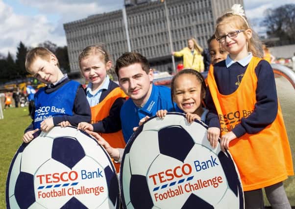 Aberdeen's Kenny McLean joins (L/R) Aaron Koziel, Maisy Le Poidevin, Michael Igwegbu, Zuzanna Obianwu and Maya Witowska from St. Peter's Primary School as he promotes the Tesco Bank Football Challenge. Picture: Gary Hutchison/SNS