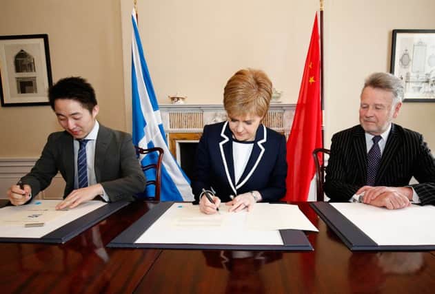Nicola Sturgeon, flanked by Peter Zhang (left) and Sir Richard Heygate. Picture: Sinofortone Group
