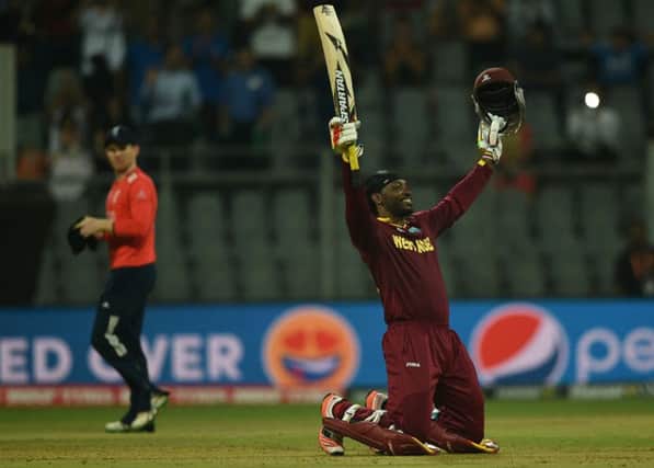 Chris Gayle, top, celebrates West Indies win over England in the group stages. Picture: AFP/Getty