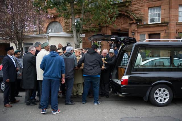 Mourners with Asad Shah's coffin. Picture: John Devlin