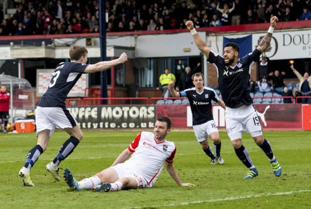 Craig Wighton (left) celebrates with his team mates after adding Dundee's fourth goal. Picture: SNS Group