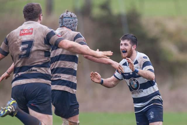 Heriots players rush to congratulate Gregor McNeish after he put over the winning drop-kick. Picture: Toby Williams