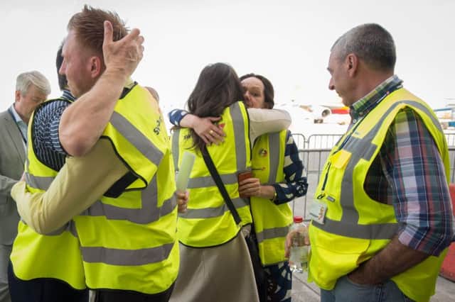 Brussels Airport workers celebrate after the flight to Faro, Portugal takes off yesterday. Two more flights were scheduled last night. Picture: AFP/Getty
