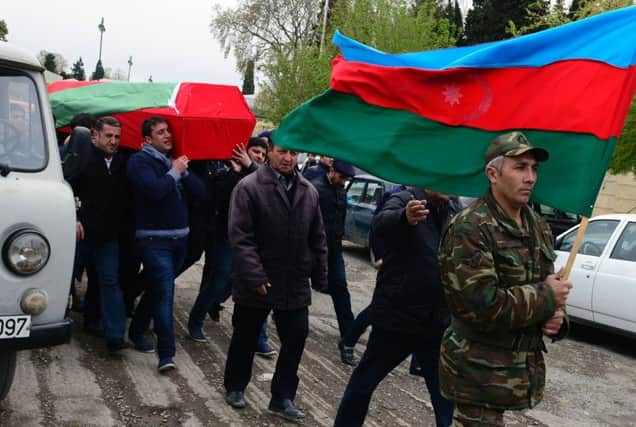 Men carry the coffin of an Azerbaijani serviceman, who was killed during clashes in  the region of Nagorny Karabakh. Picture: AFP/Getty
