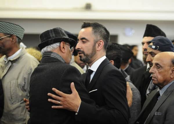 Aamer Anwar with the family of Asad Shah, the shopkeeper who was murdered in Glasgow and whose funeral was held yesterday. Picture: John Devlin
