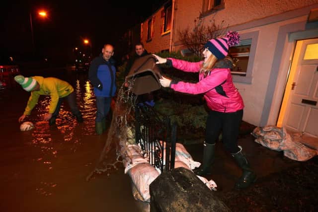 People in Peebles try to limit the damage after the Tweed burst its banks at the end of last year. Picture: Getty