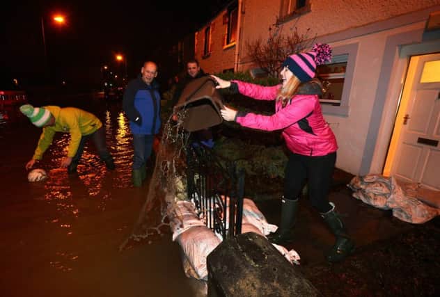 People in Peebles try to limit the damage after the Tweed burst its banks at the end of last year. Picture: Getty