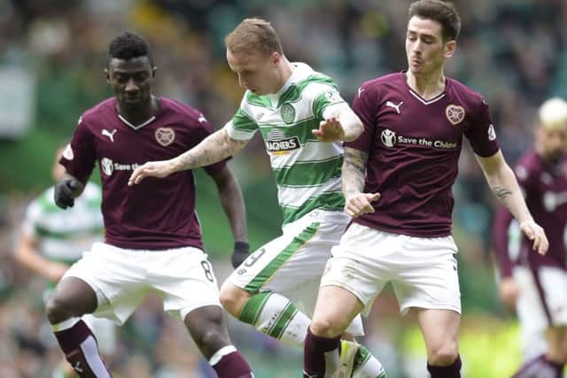 Celtic's Leigh Griffiths (centre) gets between Prince Buaben (left) and Jamie Walker. Picture: SNS