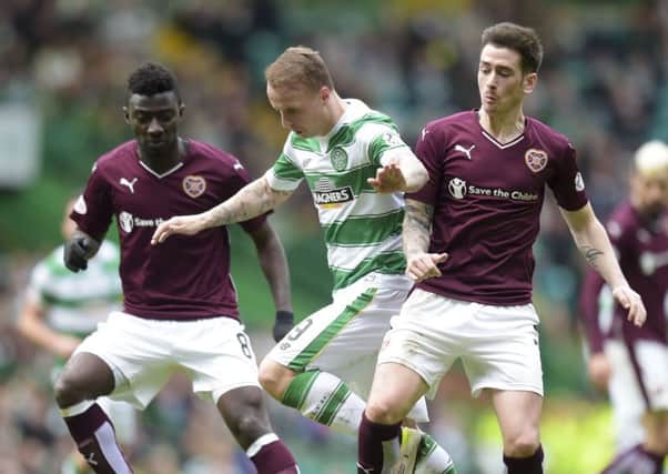 Celtic's Leigh Griffiths (centre) gets between Prince Buaben (left) and Jamie Walker. Picture: SNS