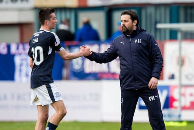 Dundee manager Paul Hartley (right) celebrates with Cameron Kerr after the win over Ross County. Picture: SNS