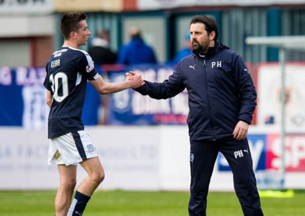 Dundee manager Paul Hartley (right) celebrates with Cameron Kerr after the win over Ross County. Picture: SNS