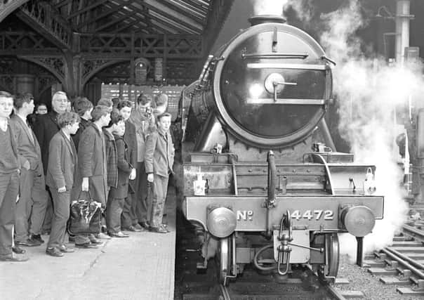 Trainspotters gather to see the Flying Scotsman when she leaves Waverley station in Edinburgh for Aberdeen