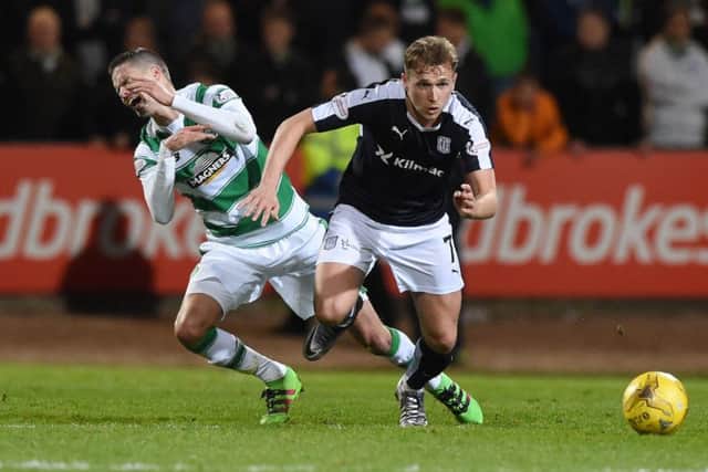 Celtic's Mikael Lustig (left) battles for the ball against Dundee's Greg Stewart. Picture: SNS