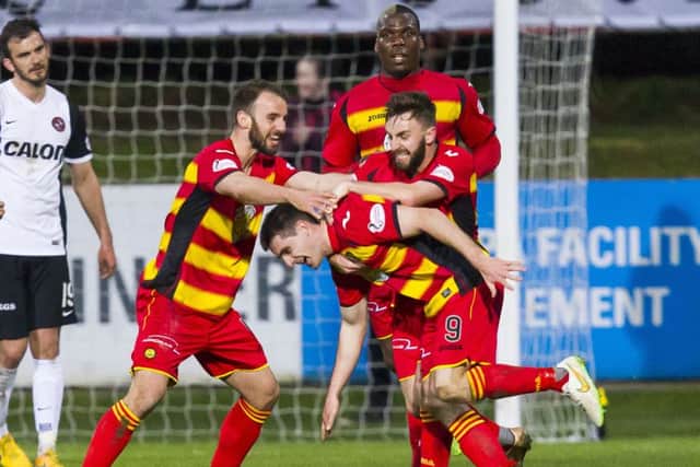 Partick Thistle's Kris Doolan (9) celebrates with teammates after he scoring the winning goal. Picture: SNS