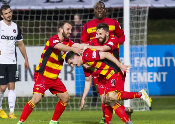 Partick Thistle's Kris Doolan (9) celebrates with teammates after he scoring the winning goal. Picture: SNS