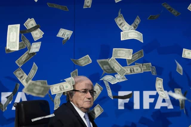 Ex-Fifa president Sepp Blatter was showered with fake notes as news of scandal around the football body broke. Picture: Getty Images