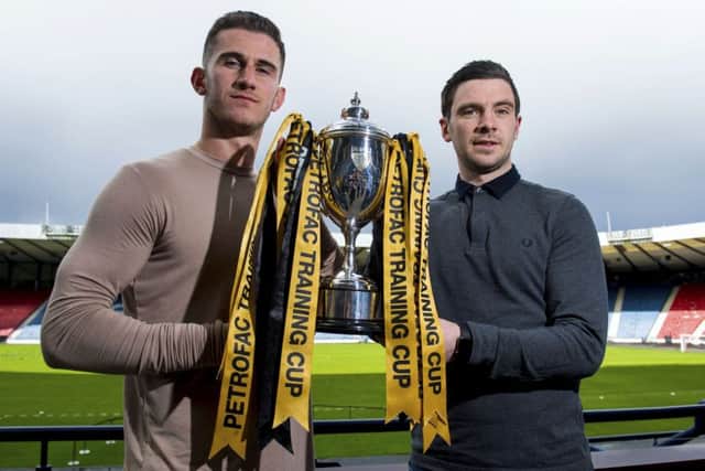 Rangers defender Dominic Ball, left, joins Peterhead captain Steven Noble. Picture: SNS