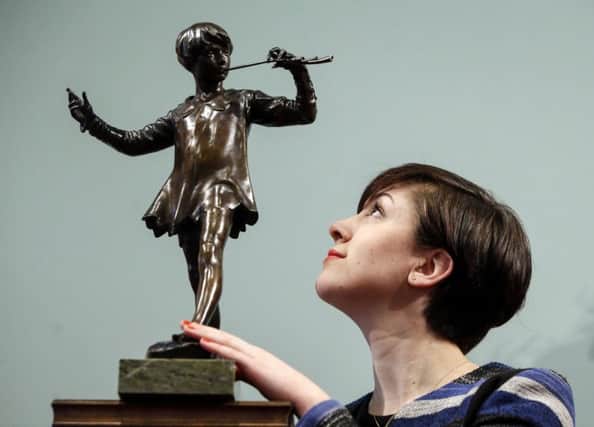 Lyon and Turnbull's Hannah Willetts with a model of Sir George Frampton's bronze sculpture of JM Barrie's Peter Pan. Picture: PA