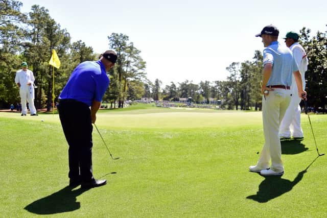 Sandy Lyle shows Russell Knox how to play a 'blade' shot from close to the green at Augusta National. Picture: Getty Images