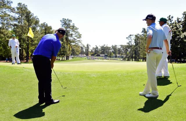 Sandy Lyle shows Russell Knox how to play a 'blade' shot from close to the green at Augusta National. Picture: Getty Images